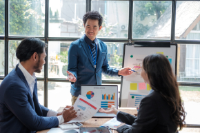 Colleagues meeting discuss business project planning, marketing strategies, and financial report analysis for business investment planning.